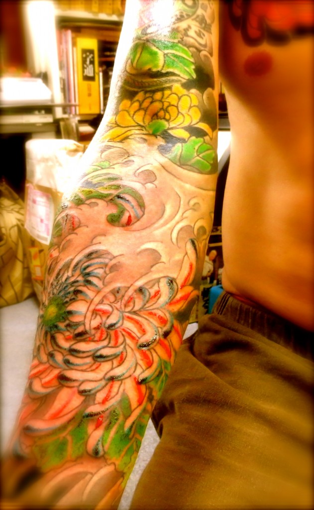 A fresh tattoo, the red ink of chrysanthemum petals looks like blood