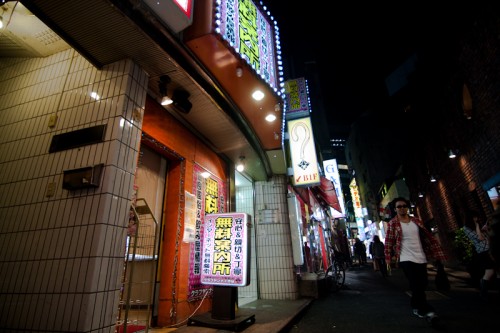 A "free information center" providing locations of adult entertainment businesses lies on a heavily-trafficked street.