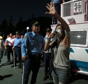 Misao Redwolf working with the police to keep the protests peaceful. 