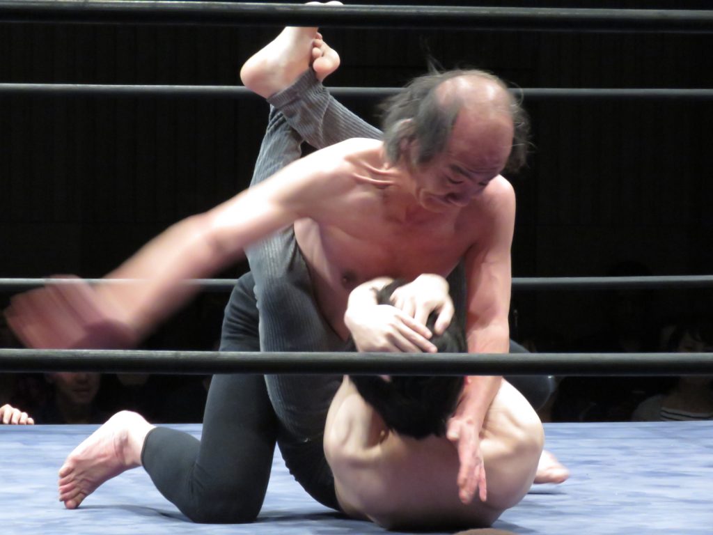 The wrestler “Alcoholism” pummels his opponent, "Worthless Goro",  who suffers from depression during the 25th anniversary Doglegs match.  April 15th 2016, photo taken by Jake Adelstein  *Alcoholism is the older man